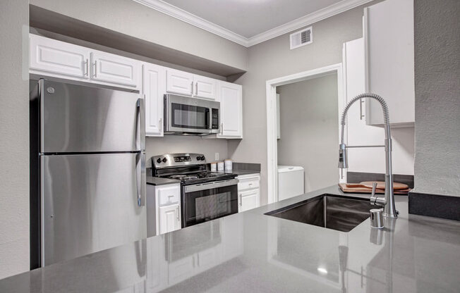a kitchen with a sink and a refrigerator
