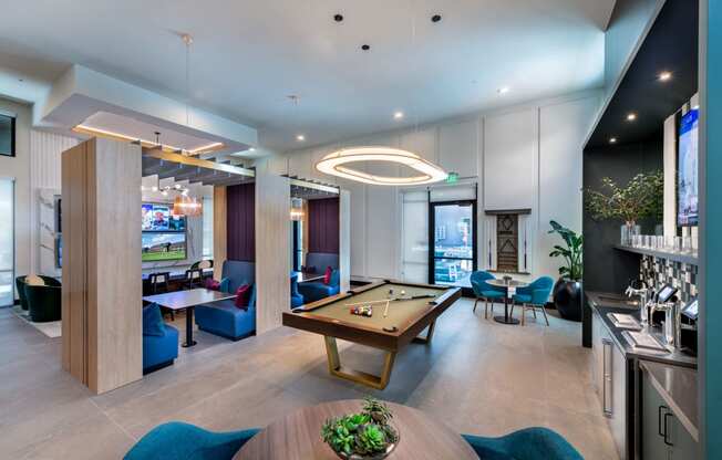 a lounge area with a pool table and a bar