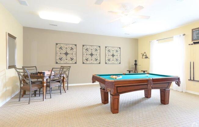 a game room with a pool table and a dining area