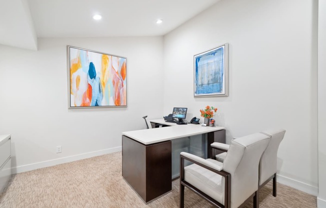 a home office with a desk and two chairs