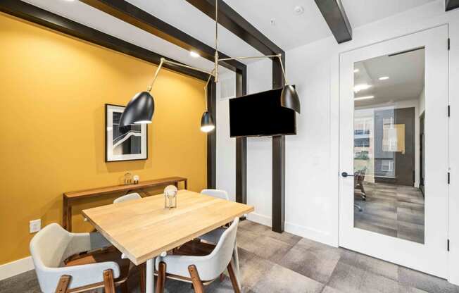 a dining room with a table and chairs and a tv