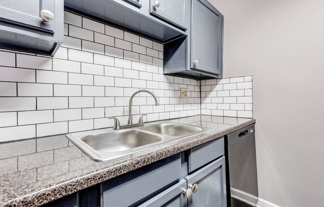Whitney Manor Apartments in Gretna, LA photo of  a kitchen with a sink and white subway tiles