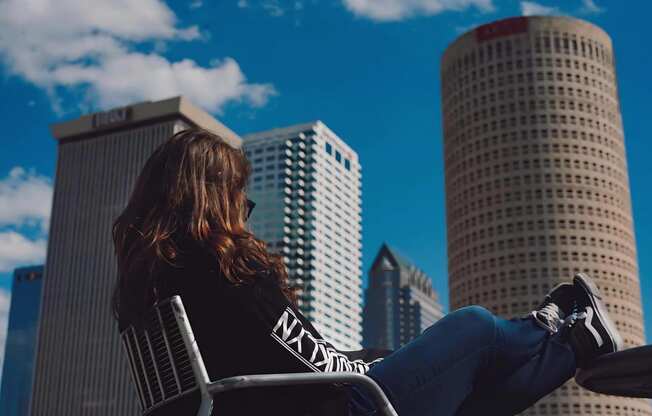 Woman Sitting Against Tampa Skyline