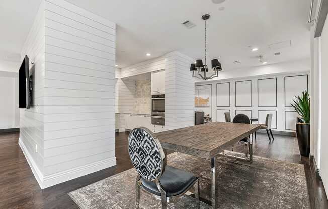 A modern dining room with a wooden table and chairs.