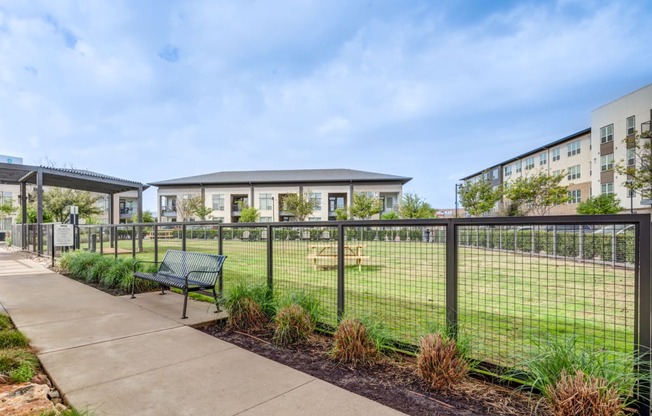 the preserve at ballantyne commons fenced in yard with benches and buildings