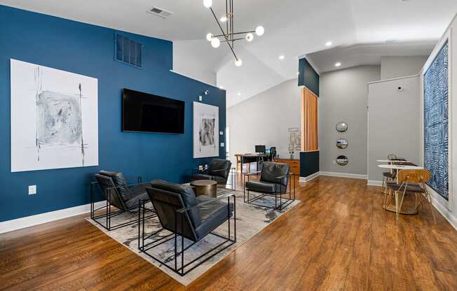 A living room with a blue wall and a television.