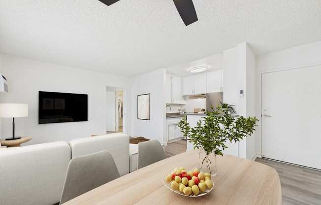 A modern living room with a wooden table and a bowl of fruit on it.