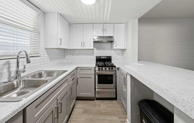 a kitchen with white cabinets and a white counter top