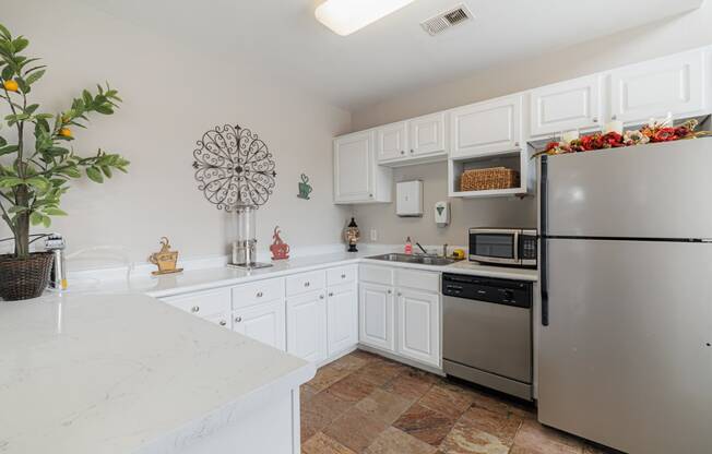 a kitchen with stainless steel appliances and white cabinets