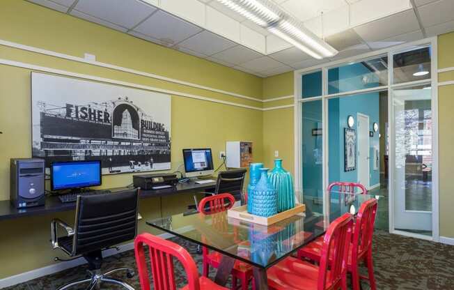 a conference room with a glass table and chairs at Village Club of Royal Oak, Royal Oak