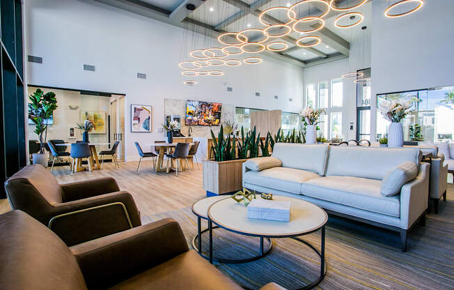 A modern living room with a variety of seating options and a coffee table.