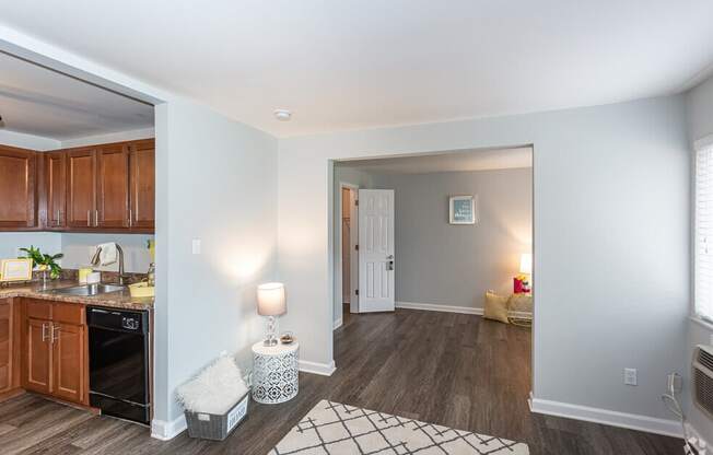 the view of a living room and kitchen with a door to a bedroom