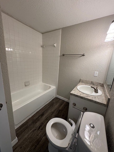 A white toilet sits next to a sink in a small bathroom.