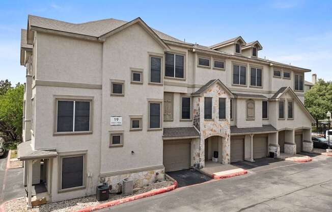 A large two-story building with a garage on the lower level.
