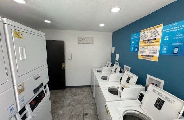 a laundry room with a bunch of washes and dryers