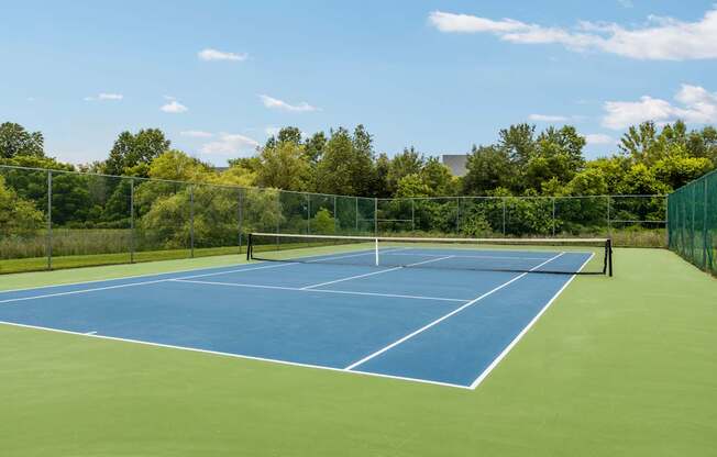 A tennis court with a net and no players.