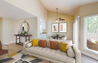 A living room with a white couch and a rug on the floor.