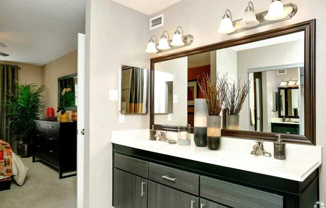 a bathroom with a large mirror and a sink
