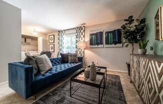 Ashton Brook Apartments offer an open living and dining area with access to a patio.
