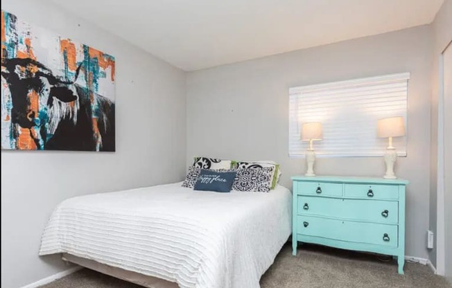 a bedroom with a bed and a ceiling fan