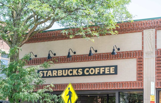 a sign on the front of a starbucks coffee shop