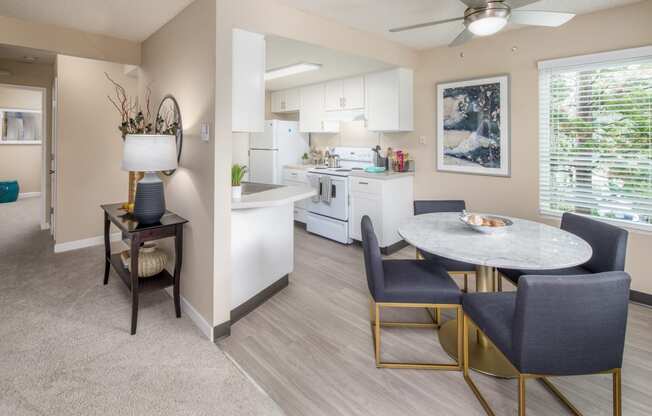 an open kitchen and dining room with a table and chairs