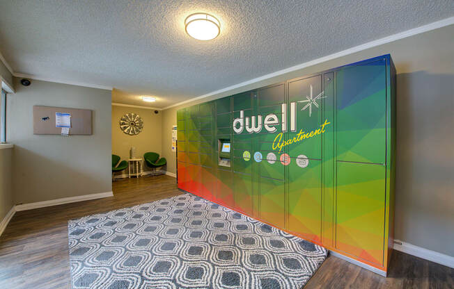 a room with a rug and a large sign on the wall at Dwell Apartment Homes, Riverside, CA