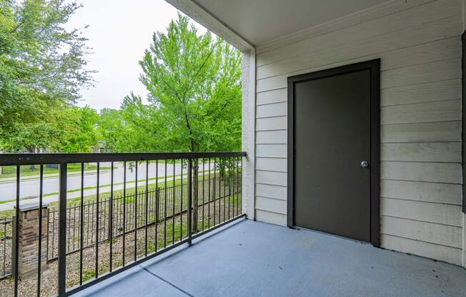 the balcony of a building with a door to a patio
