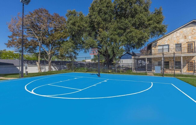 Welcome to Distinction Apartment Homes, where vibrant outdoor spaces await you! Enjoy an energetic lifestyle with our stunning blue sports court perfect for friendly matches and fitness fun. Schedule a tour today and elevate your living experience!