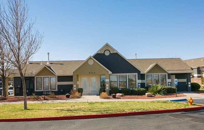 A row of houses with a yellow fire hydrant in front of them.