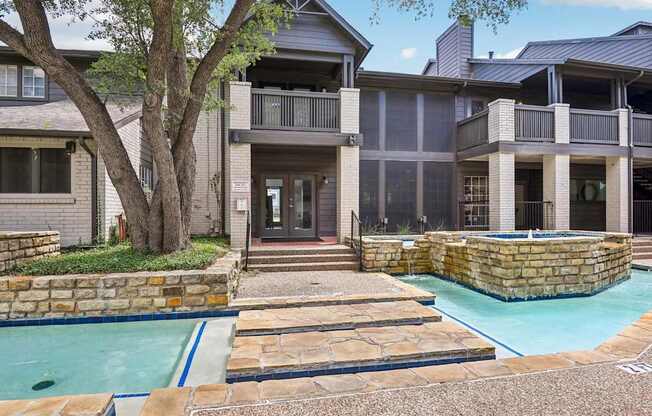 A large house with a pool in front.