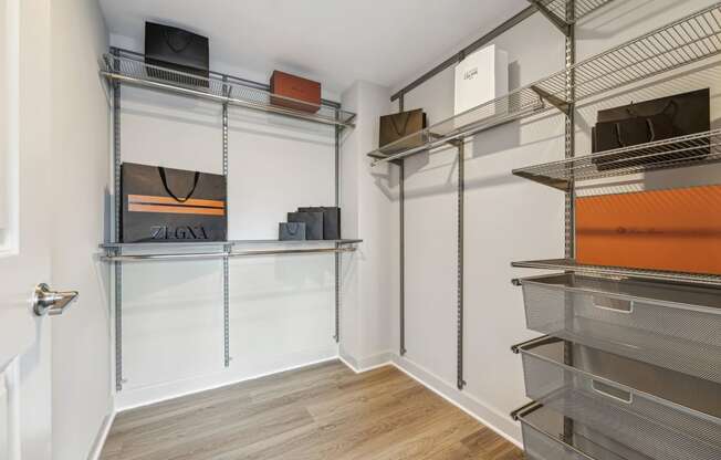 a room with a closet with shelves and a television