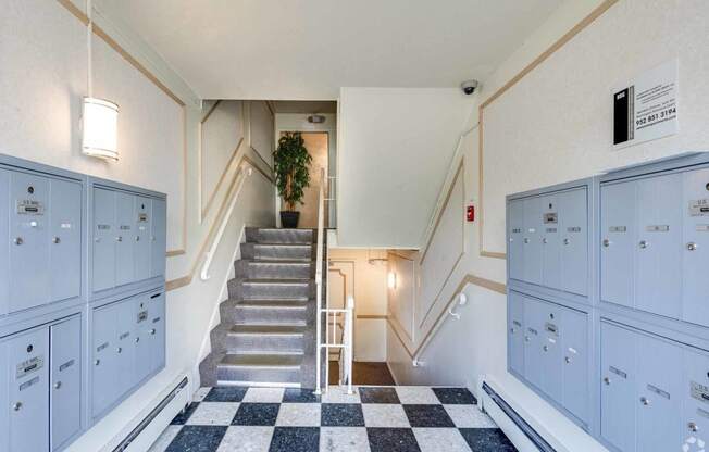 the lobby of a building with blue lockers and stairs