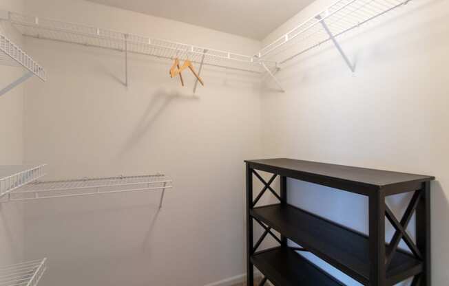 This is a photo of the second bedroom walk-in closet of the 890 square foot 2 bedroom, 2 bath Liberty at Washington Place Apartments in in Miamisburg, Ohio in Washington Township.