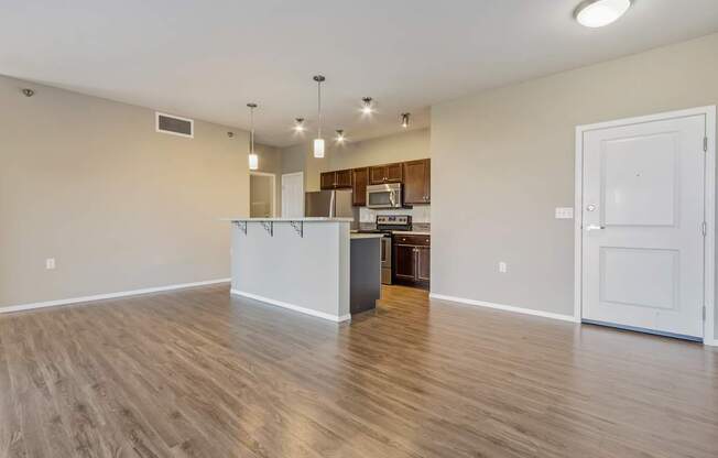 A kitchen area with a white countertop and wooden flooring.