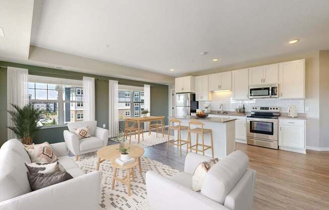 A modern living room with a kitchen in the background.