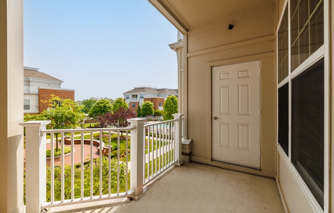 A white door is on the right side of a balcony.