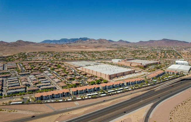 A large industrial complex is surrounded by a desert landscape.
