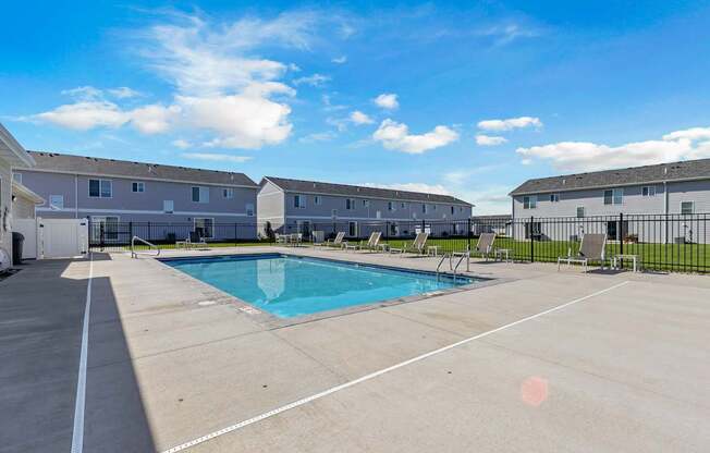 A swimming pool in a sunny outdoor setting.