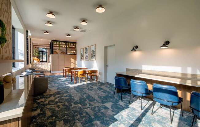 A room with a long table and chairs.