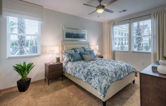 a bedroom with a bed and a ceiling fan