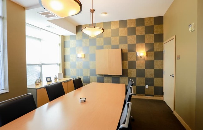 A conference room with a long table and chairs.