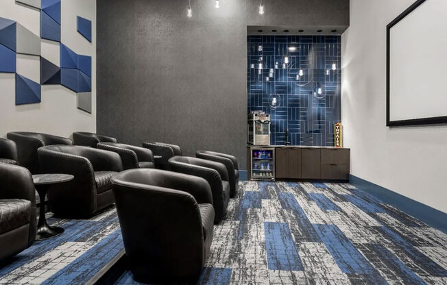 A room with black chairs and a blue carpet.