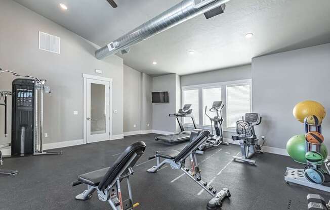 A spacious home gym with a variety of exercise equipment.