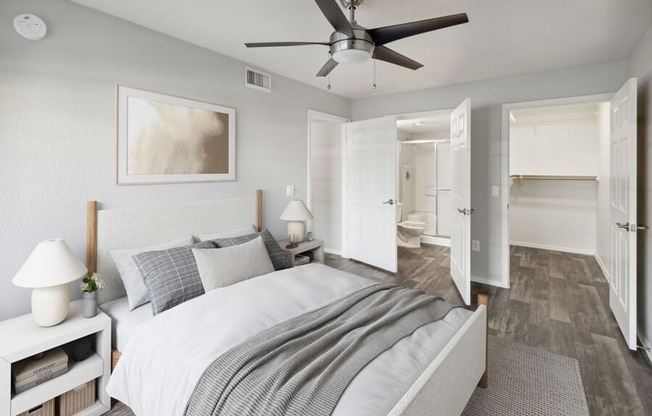 a bedroom with a ceiling fan and a bed