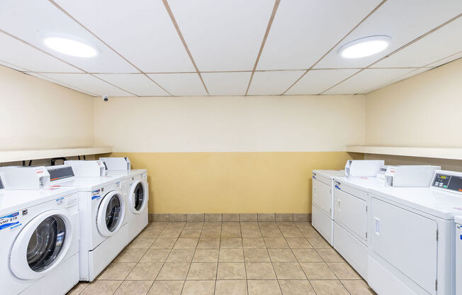 a washer and dryer in a laundry room with washes and washing machines