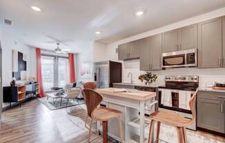 a kitchen and living room with a table and chairs at The Jane at Preston Trail, Cedar Hill, TX