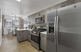 a kitchen with stainless steel appliances and a stainless steel refrigerator