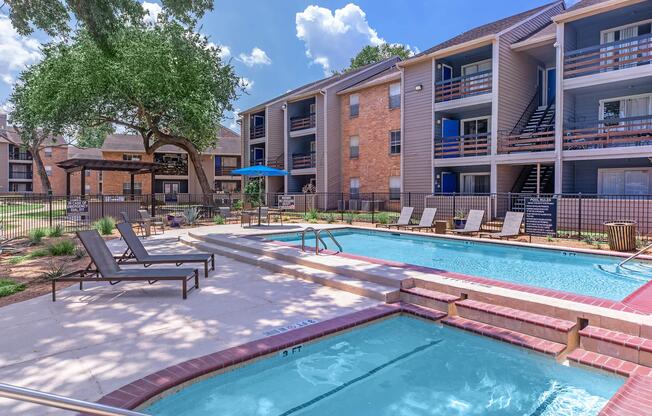 a large brick building with a pool