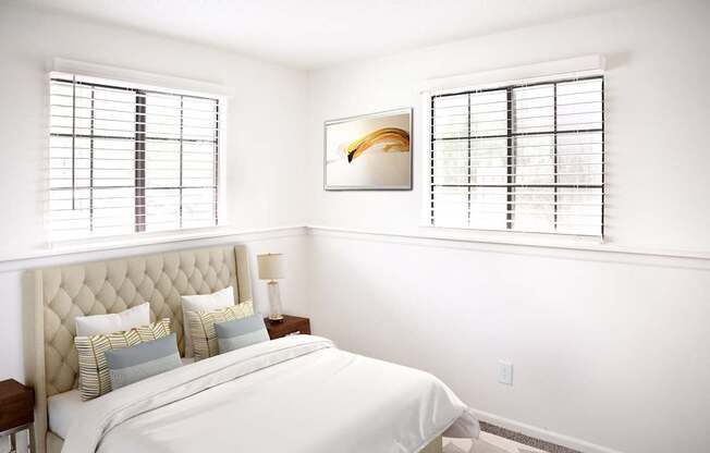 A bedroom with a large bed and a painting on the wall.